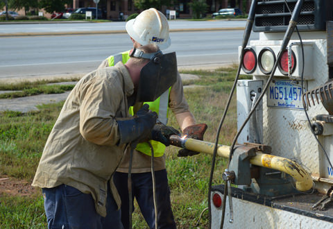 cpw employees working at the back of their truck