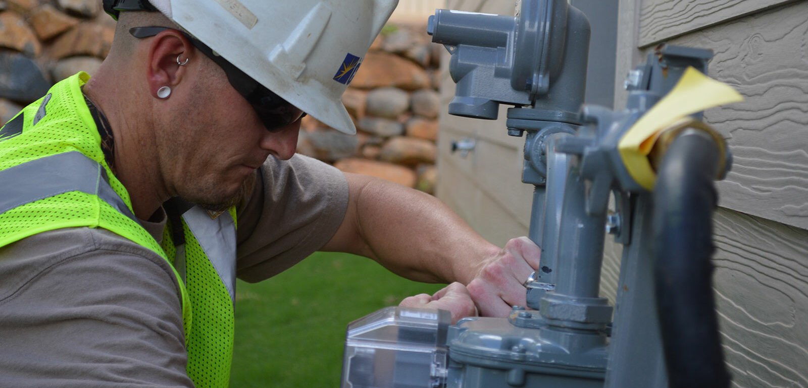 man checking meters at a house