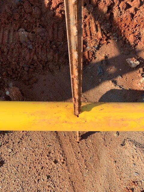 photo of a fence post going through conduit at safe digging event