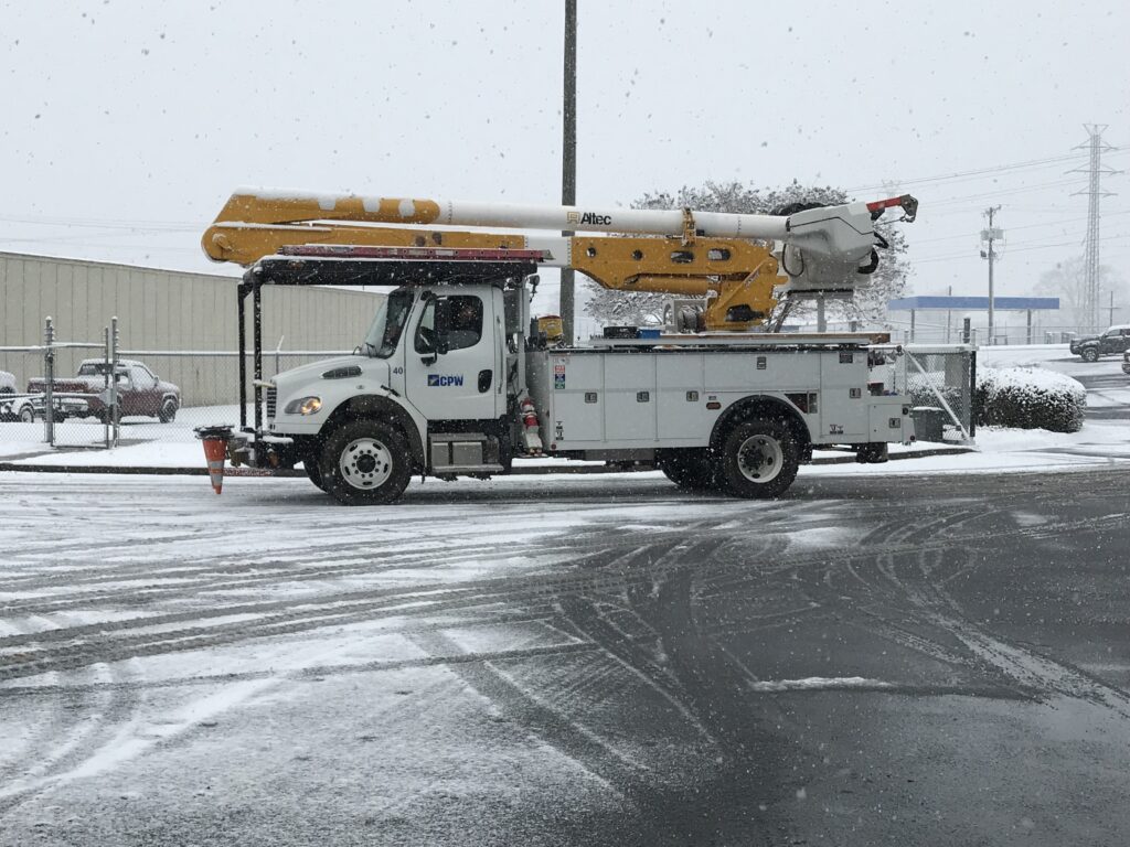 Greer CPW bucket truck in the parking lot with snow all around