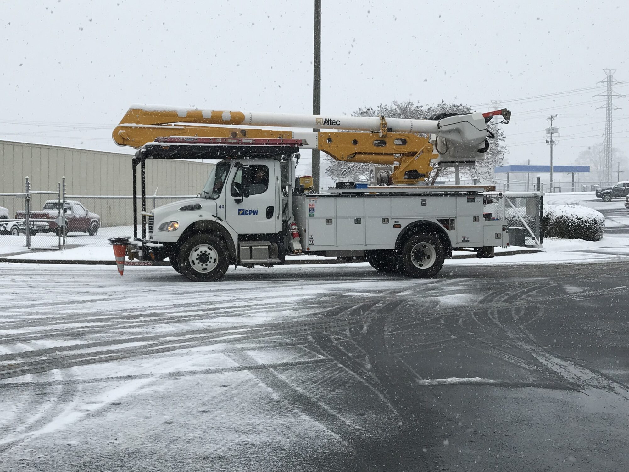 Greer CPW bucket truck in the parking lot with snow all around