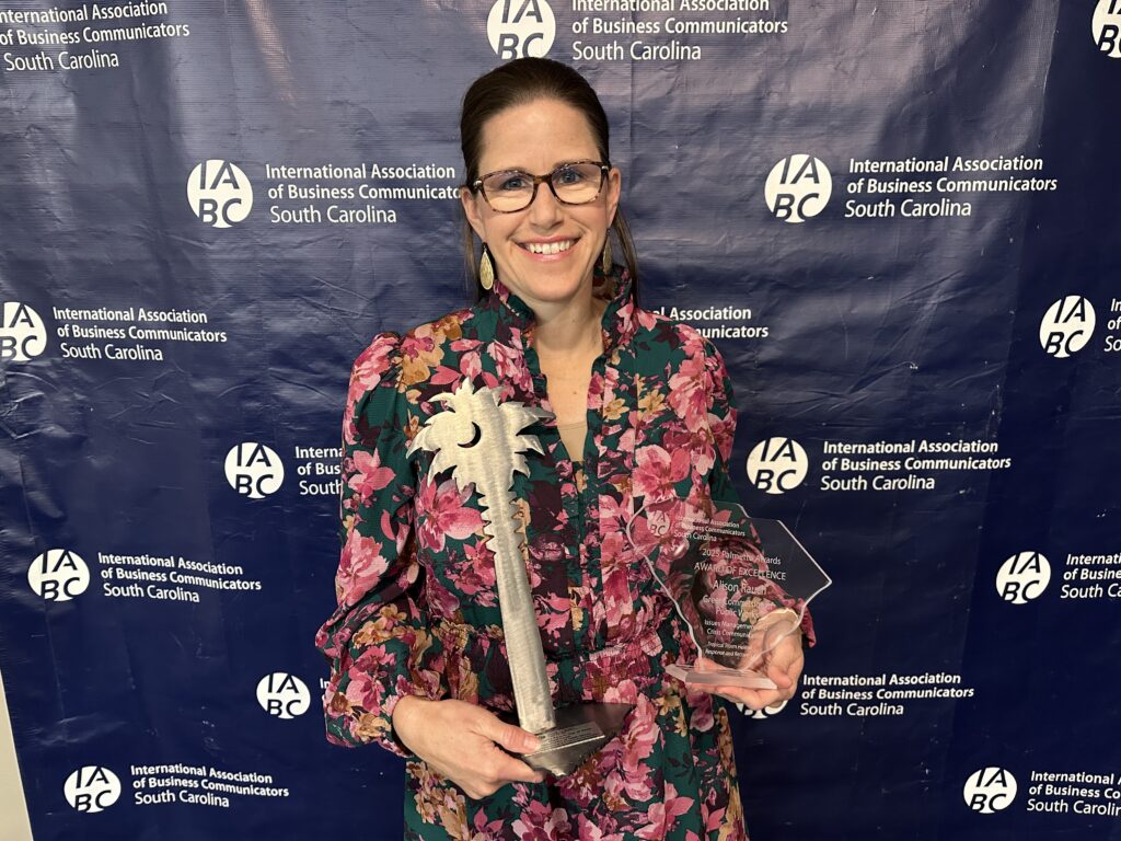 Public Information Coordinator, Alison Rauch, at the International Association of Business Communicators awards in Columbia, SC. Image shows Alison with two awards.