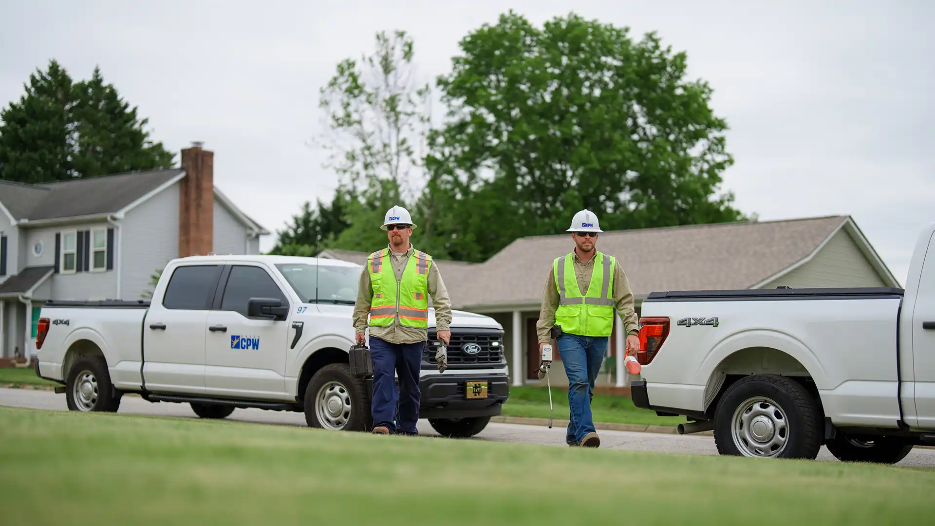 employees walking from their trucks towards a job site