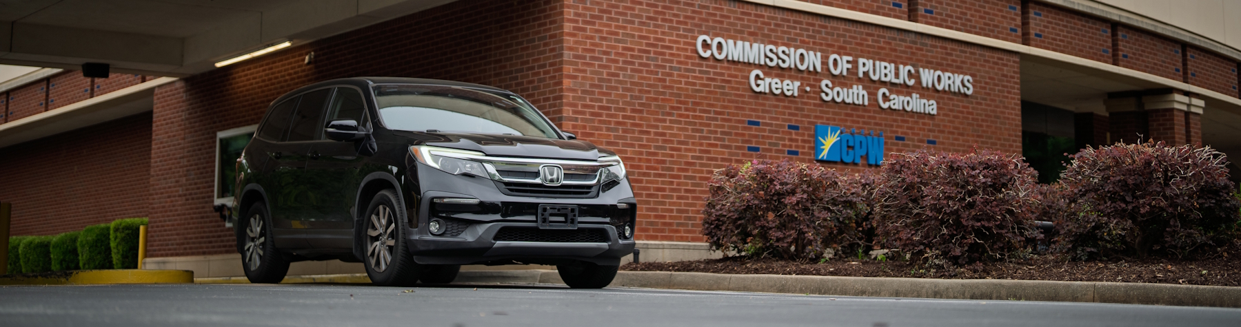 black honda suv in front of greer commission of public works