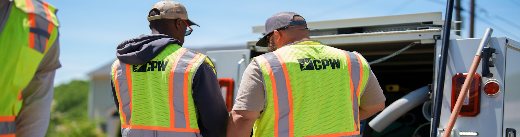 two sewer technicians discussing the job